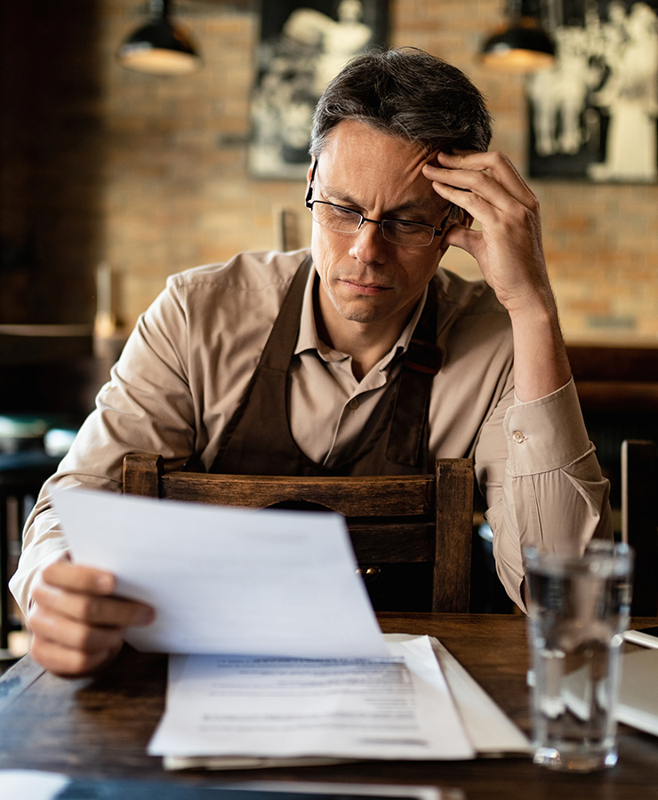 distressed business owner reviewing documents.jpg